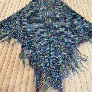 Hand knitted cape in beautiful colors. Perfect for any season. Tasseled edges.